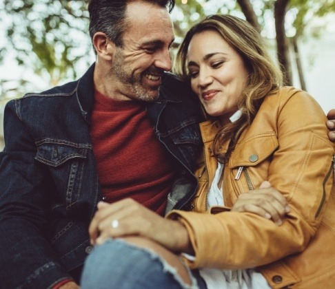 Man and woman enjoying the benefits of dental implants