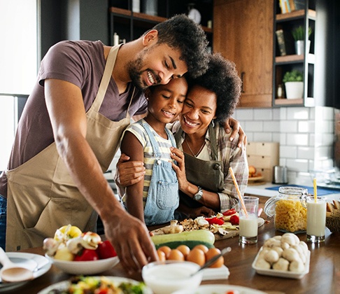 family cooking together in a kitchen