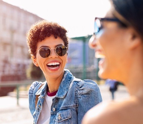 Woman with flawless smile after metal free dental restorations