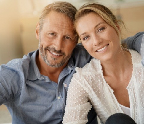 Man and woman with flawless smiles after makeovers