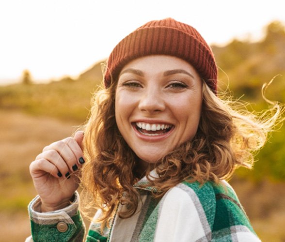 Woman smiling with a dental crown