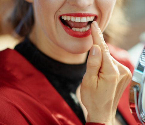 Woman pointing to her tooth