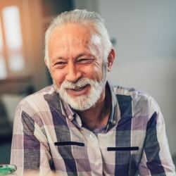 Man with full smile after replacing missing teeth