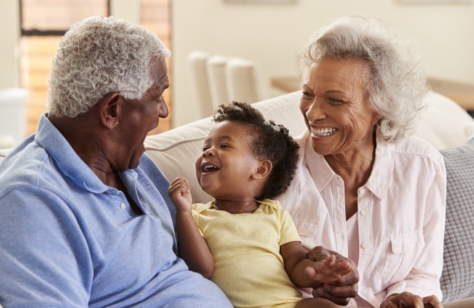 Grandparents and grandchild smiling together