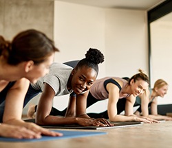 Group of women smiling during yoga class