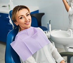 Woman smiling while sitting in treatment chair