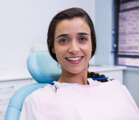 Woman smiling during dental checkup and teeth cleaning visit