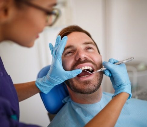 Dental patient receiving oral cancer screening