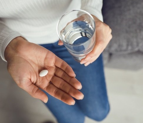 Patient holding an oral conscious dental sedation pill