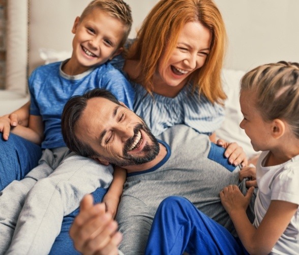 Family laughing together after receiving dental services in Sachse Texas