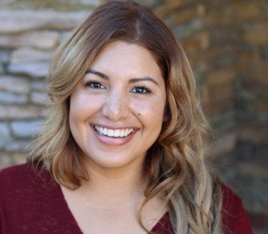 Young woman with beautiful smile after orthodontic treatment