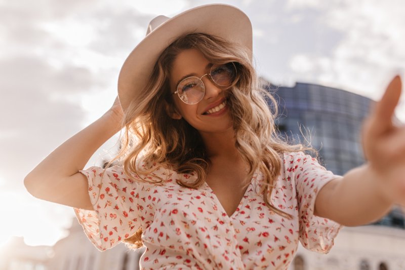 young adult with a beautiful smile standing in the sunshine