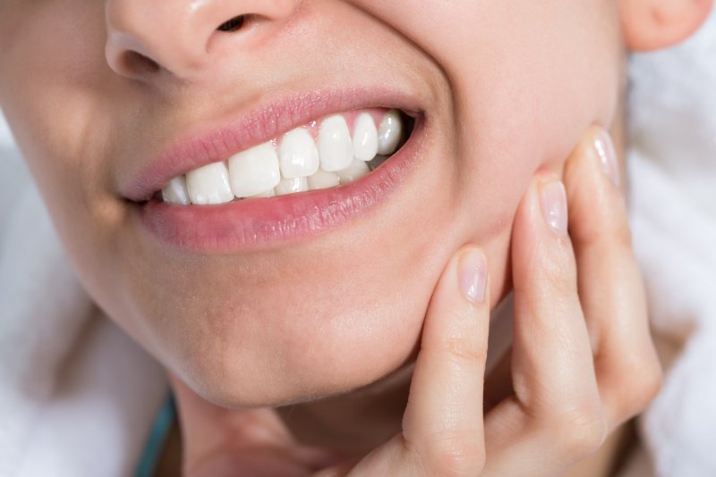 closeup of someone wincing from a toothache