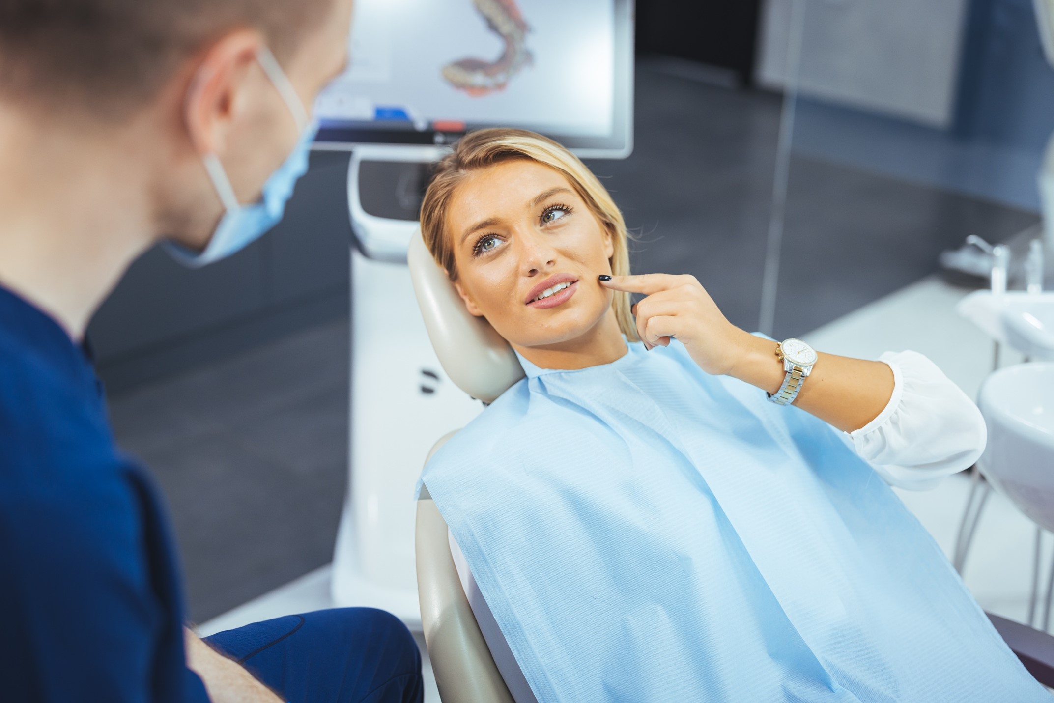 Woman talking to dentist during consultation.